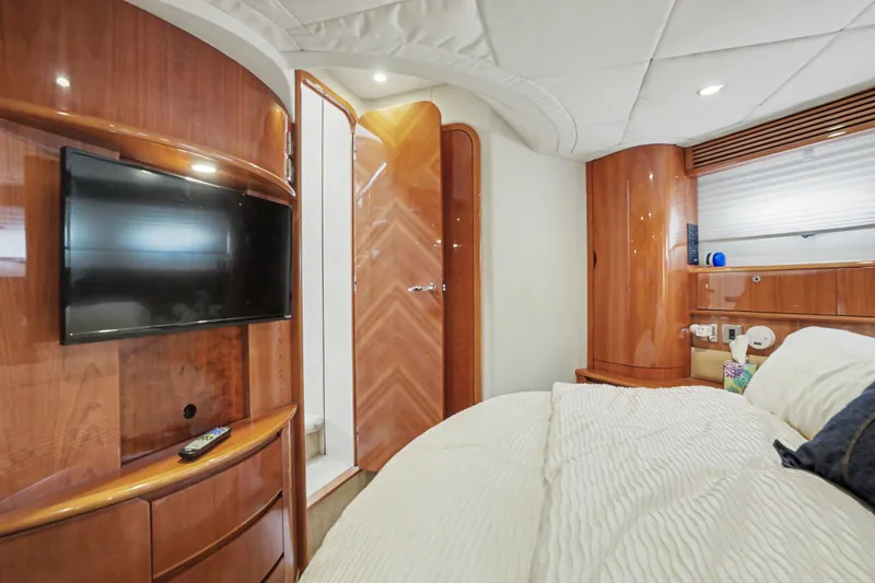 Slide: The Image of Luxurious cabin interior of 2001 Viking Sport Cruisers V65 yacht with TV and wood finish. - 34