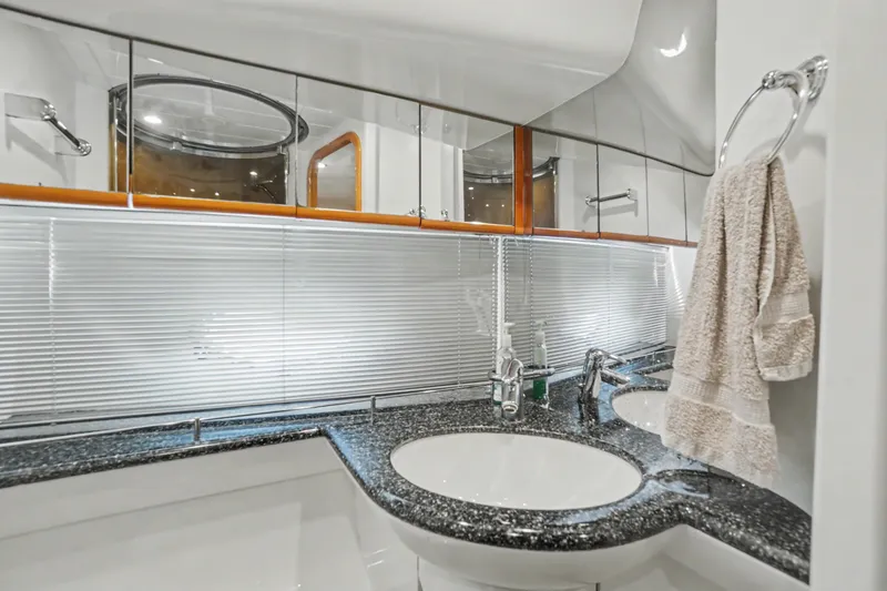 Slide: The Image of Luxurious bathroom in 2001 Viking Sport Cruisers V65 yacht with modern fixtures and elegant design. - 32