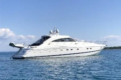 Slide: The Image of 2002 Viking Sport Cruisers V65 yacht on calm blue water under clear sky. - 26
