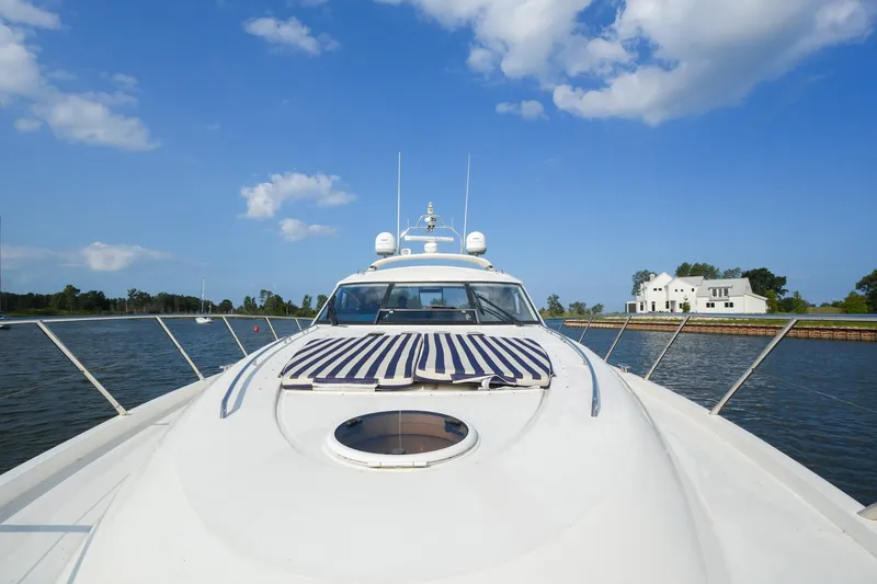 Slide: The Image of 2001 Viking Sport Cruisers V65 yacht on calm water under blue sky. - 20