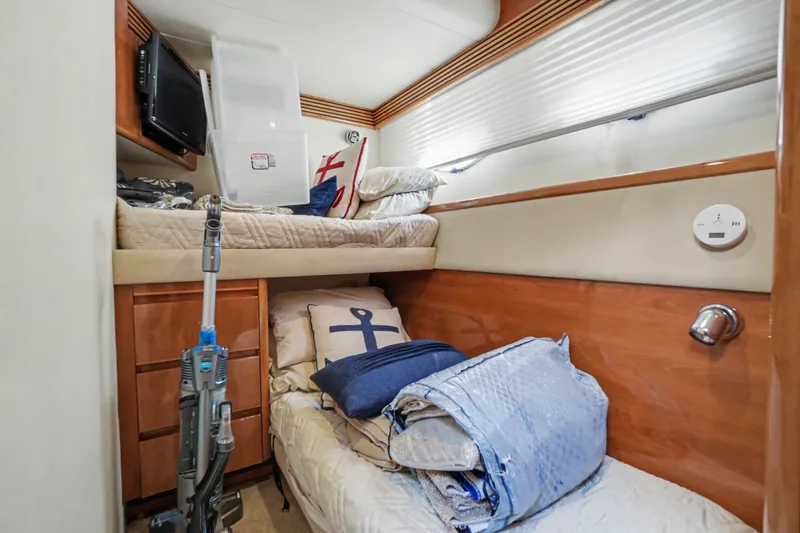 Slide: The Image of Cozy cabin interior of 2001 Viking Sport Cruisers V65 with bunk beds and nautical decor. - 36