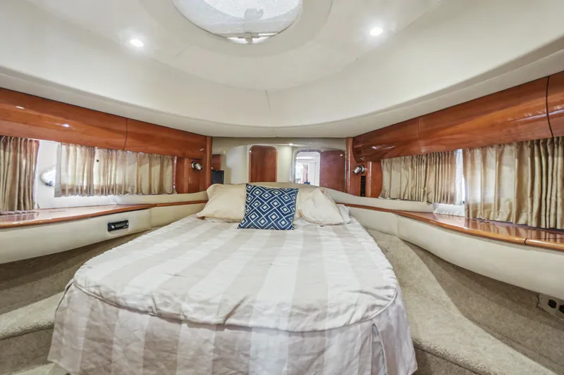 Slide: The Image of Luxurious cabin interior of 2001 Viking Sport Cruisers V65 yacht with elegant bedding and wood accents. - 30