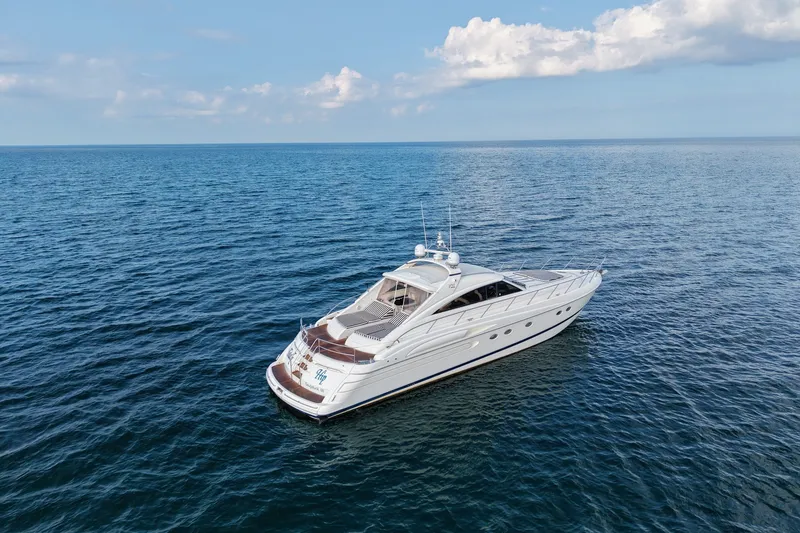 Slide: The Image of 2001 Viking Sport Cruisers V65 yacht cruising on open sea under clear sky. - 3