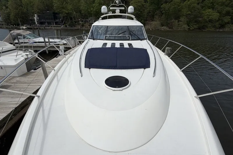 Slide: The Image of 2001 Viking Sport Cruisers V65 yacht docked by a serene lakeside. - 64