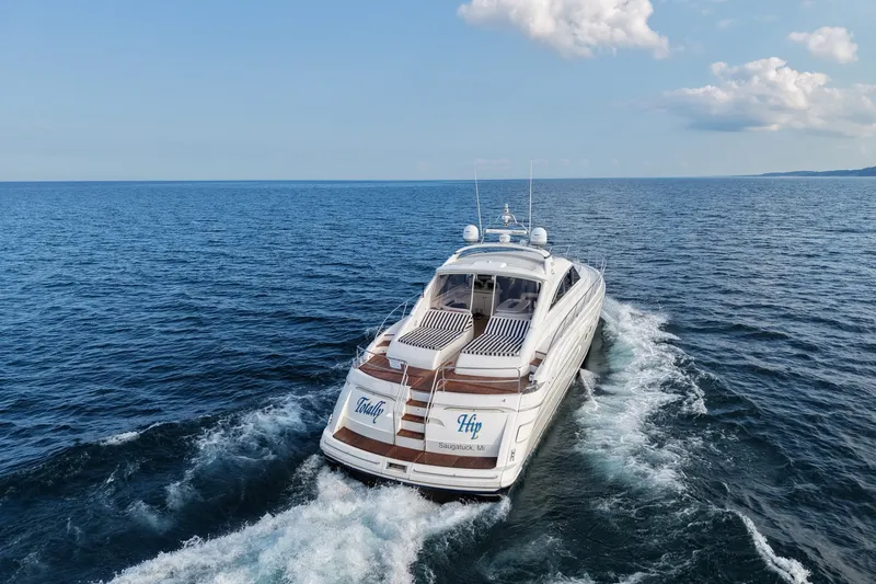 Slide: The Image of Luxury 2001 Viking Sport Cruisers V65 yacht cruising on open sea under blue sky. - 8
