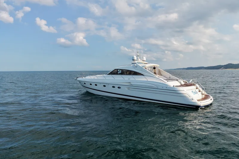 Slide: The Image of 2001 Viking Sport Cruisers V65 yacht cruising on open water under a partly cloudy sky. - 6