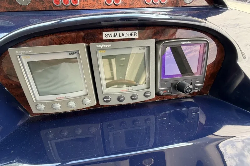 Slide: The Image of 2001 Viking Sport Cruisers V65 dashboard with Raymarine navigation displays. - 67