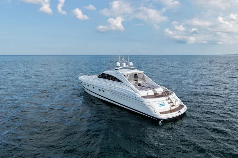 The Image of 2001 Viking Sport Cruisers V65 yacht cruising on open sea under blue sky. - 0