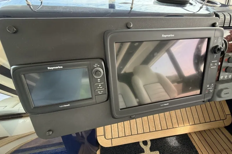 Slide: The Image of Raymarine navigation displays on 2001 Viking Sport Cruisers V65 yacht dashboard. - 55