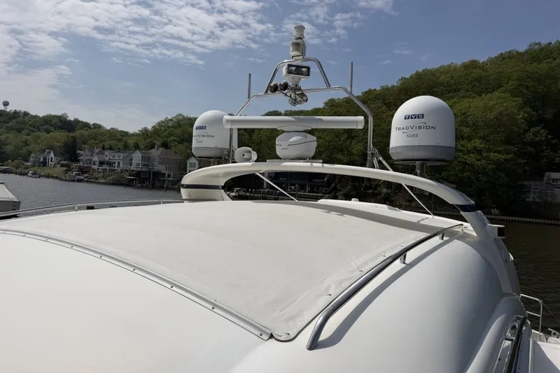 Slide: The Image of 2001 Viking Sport Cruisers V65 yacht with radar equipment, docked near waterfront homes. - 54