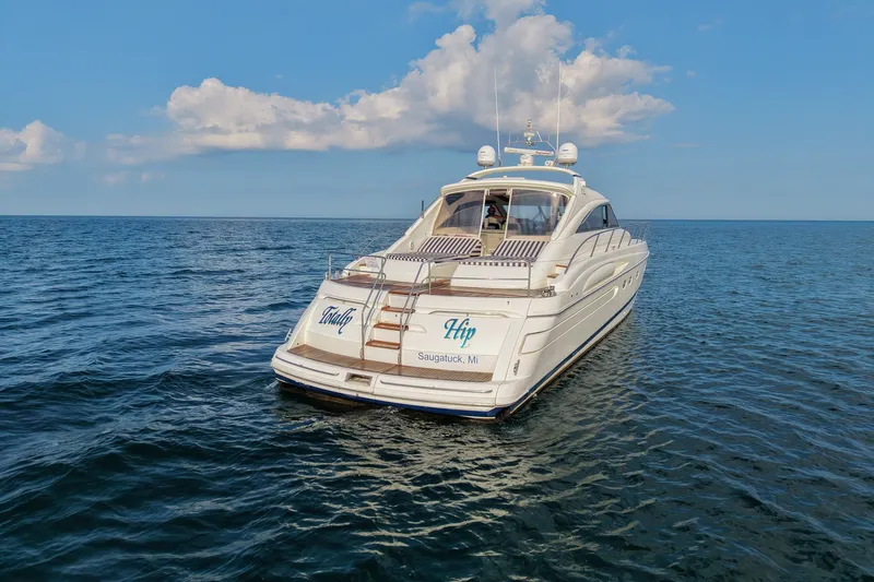 Slide: The Image of 2001 Viking Sport Cruisers V65 yacht on open water under a clear blue sky. - 5