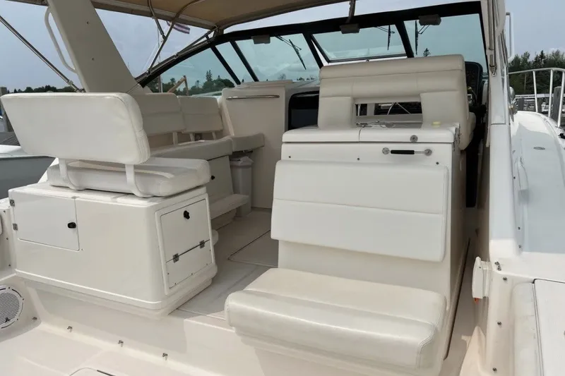 Slide: The Image of 1999 Tiara Yachts 3500 Open interior with white seating and helm station. - 12