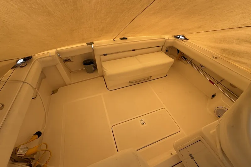 Slide: The Image of 1999 Tiara Yachts 3500 Open interior with beige seating and storage compartments. - 21