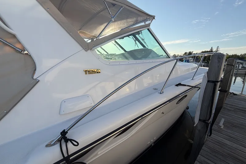 Slide: The Image of 1999 Tiara Yachts 3500 Open docked, showcasing sleek design and polished exterior. - 7