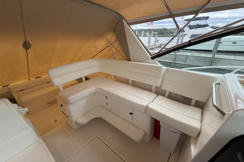 Slide: The Image of Interior view of 1999 Tiara Yachts 3500 Open with white seating and canopy. - 20