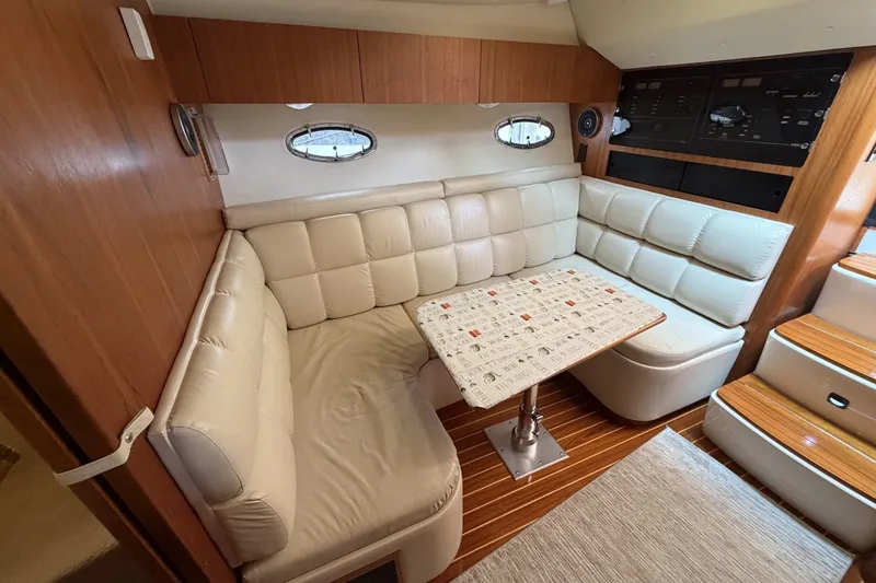 Slide: The Image of Interior of 1999 Tiara Yachts 3500 Open with plush seating and wooden accents. - 29