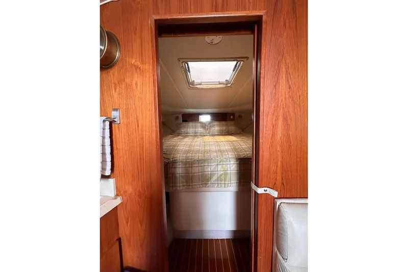 Slide: The Image of 1999 Tiara Yachts 3500 Open cabin interior with bed and wooden finish. - 42
