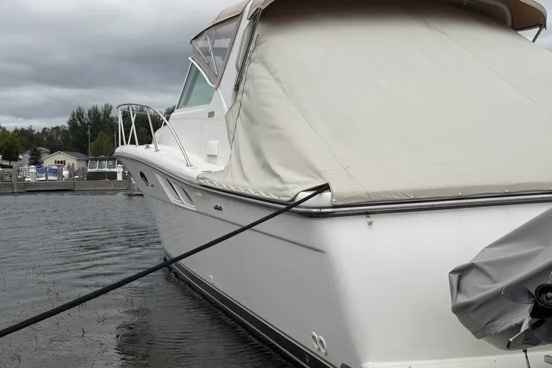 Slide: The Image of 1999 Tiara Yachts 3500 Open docked, covered, with overcast sky in the background. - 46
