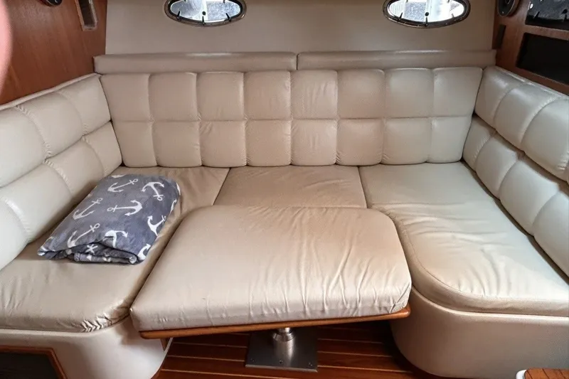 Slide: The Image of Luxurious interior of 1999 Tiara Yachts 3500 Open with plush seating and nautical blanket. - 30