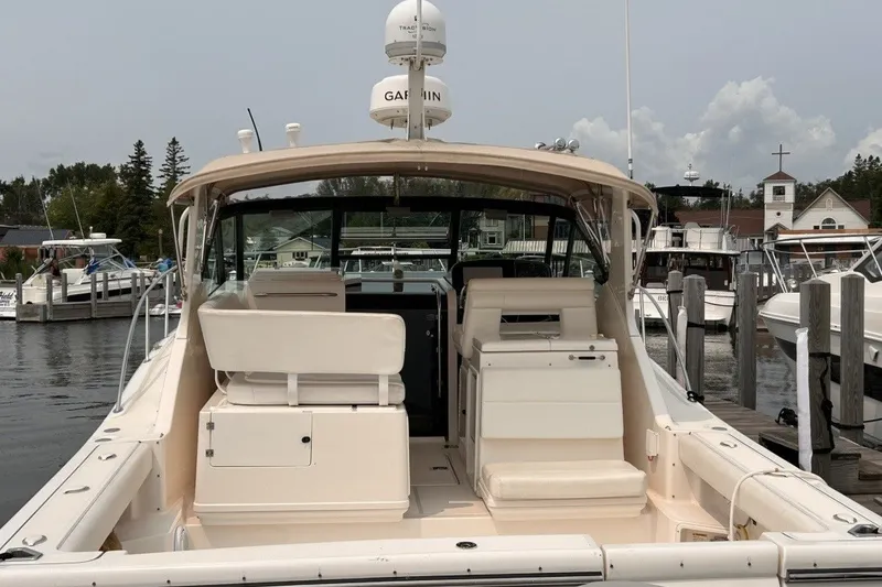 Slide: The Image of 1999 Tiara Yachts 3500 Open docked, showcasing spacious cockpit and seating area. - 13