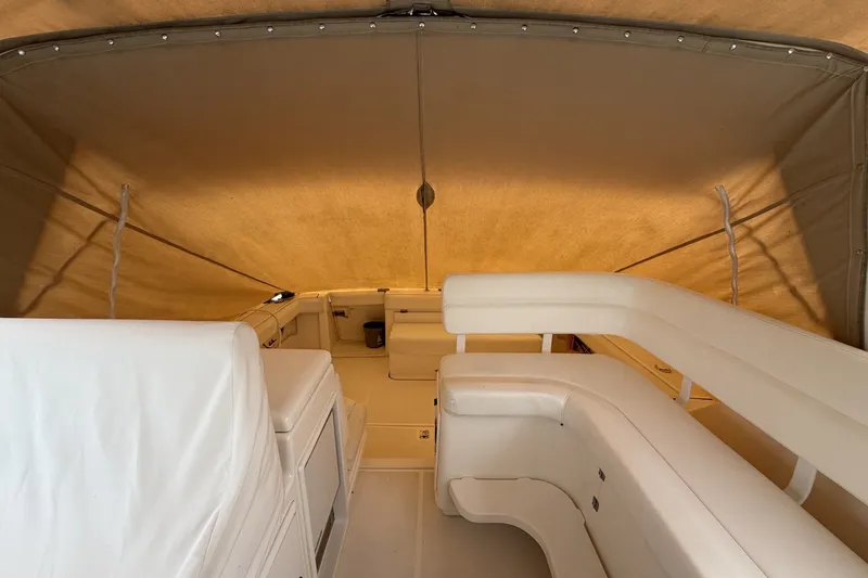 Slide: The Image of Interior view of 1999 Tiara Yachts 3500 Open with beige seating and canopy. - 23