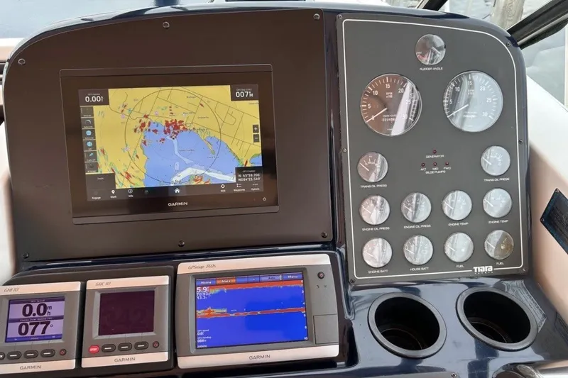 Slide: The Image of Dashboard of a 1999 Tiara Yachts 3500 Open with Garmin navigation displays. - 13