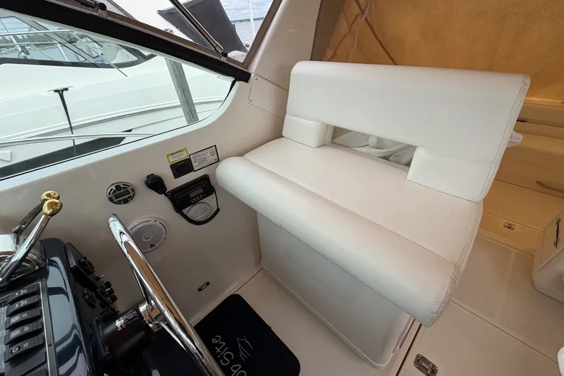 Slide: The Image of 1999 Tiara Yachts 3500 Open helm with white seating and control panel. - 19