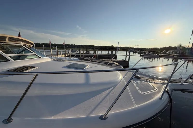 Slide: The Image of 1999 Tiara Yachts 3500 Open at sunset in a serene marina setting. - 9