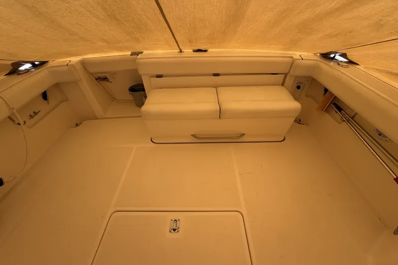 Slide: The Image of 1999 Tiara Yachts 3500 Open interior with beige seating and spacious layout. - 22
