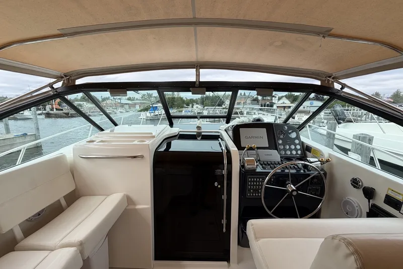 Slide: The Image of 1999 Tiara Yachts 3500 Open helm with Garmin navigation, docked at marina. - 15