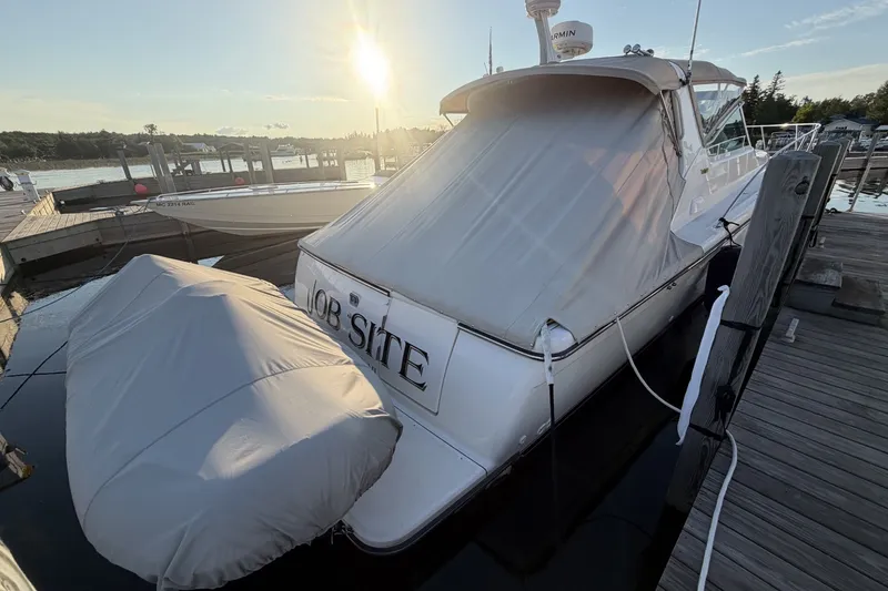 Slide: The Image of 1999 Tiara Yachts 3500 Open docked at sunset with covered stern. - 5