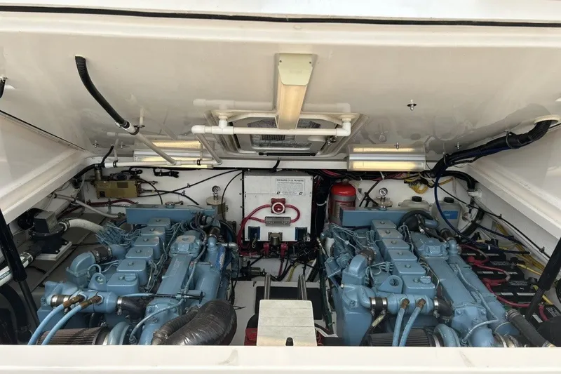 Slide: The Image of Engine compartment of a 1999 Tiara Yachts 3500 Open, showcasing dual engines and wiring. - 24