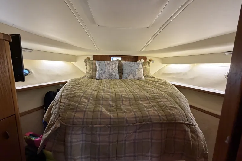 Slide: The Image of 1999 Tiara Yachts 3500 Open cabin interior with cozy bed and nautical decor. - 44
