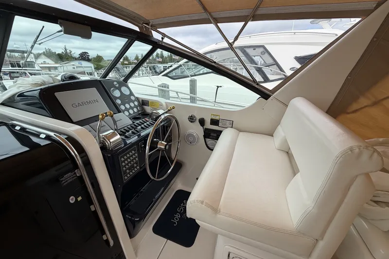 Slide: The Image of Cockpit of 1999 Tiara Yachts 3500 Open with Garmin navigation system and white seating. - 16