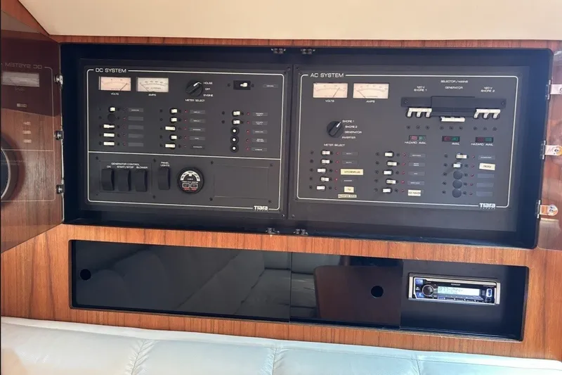 Slide: The Image of Control panel of a 1999 Tiara Yachts 3500 Open, featuring AC and DC systems. - 37
