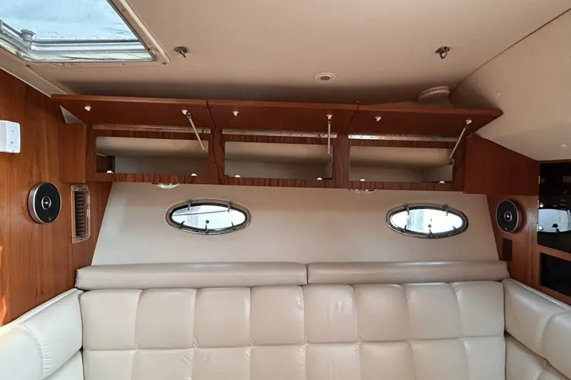 Slide: The Image of Interior of a 1999 Tiara Yachts 3500 Open with leather seating and wooden cabinetry. - 39