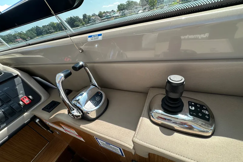 Slide: The Image of Control panel of a 2017 Sea Ray Sundancer 460 yacht, featuring throttle and joystick controls. - 24