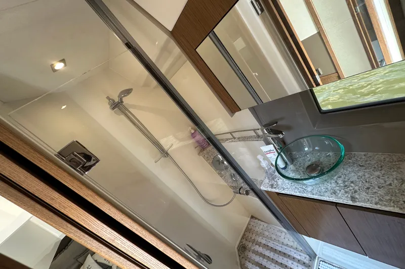 Slide: The Image of Luxurious bathroom in 2017 Sea Ray Sundancer 460 yacht with modern fixtures and glass sink. - 32