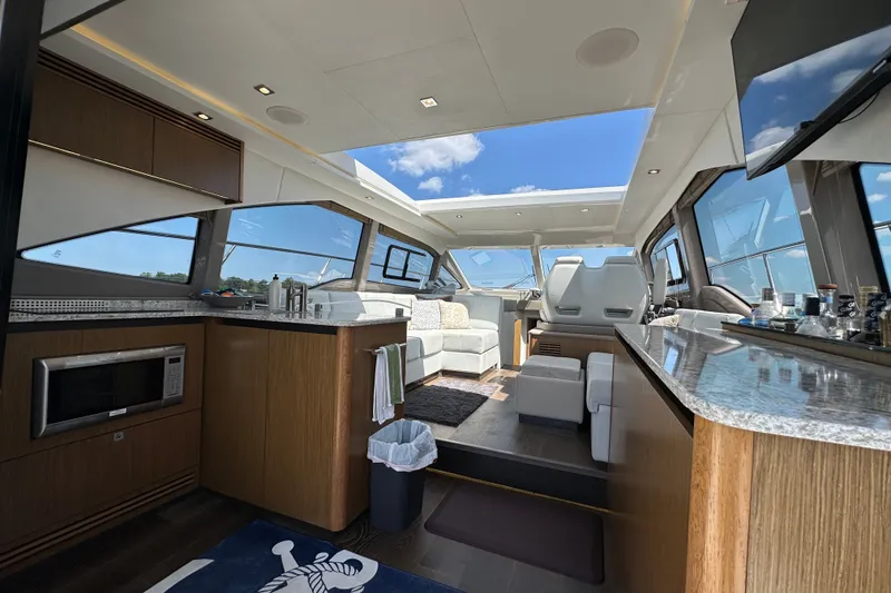 Slide: The Image of Luxurious interior of 2017 Sea Ray Sundancer 460 yacht with modern kitchen and seating area. - 10