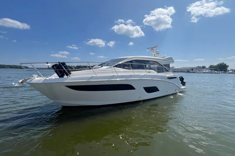 Slide: The Image of 2017 Sea Ray Sundancer 460 yacht on calm water under a clear blue sky. - 1