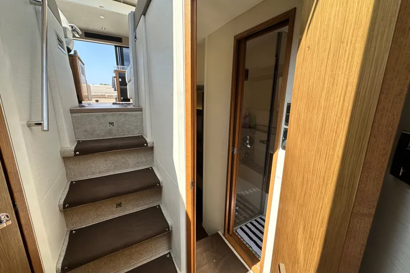 Slide: The Image of Interior view of 2017 Sea Ray Sundancer 460 yacht, featuring stairs and a bathroom. - 26