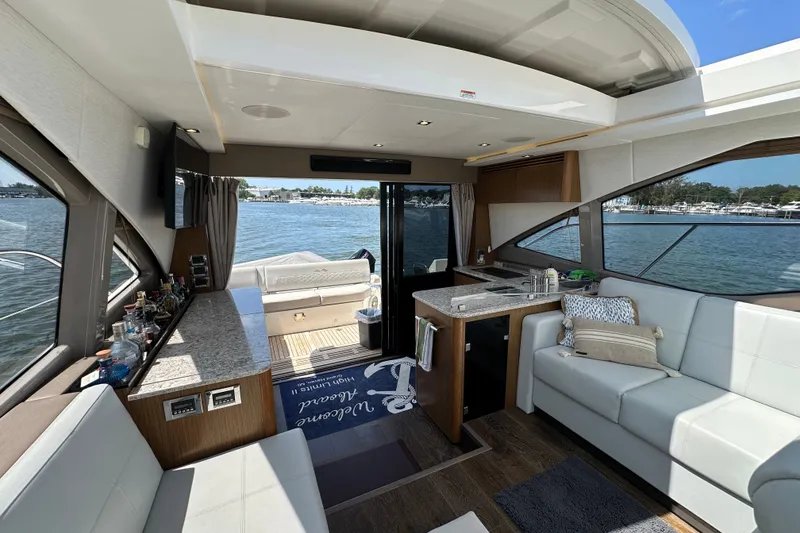 Slide: The Image of Luxurious interior of 2017 Sea Ray Sundancer 460 yacht with elegant seating and scenic water view. - 17