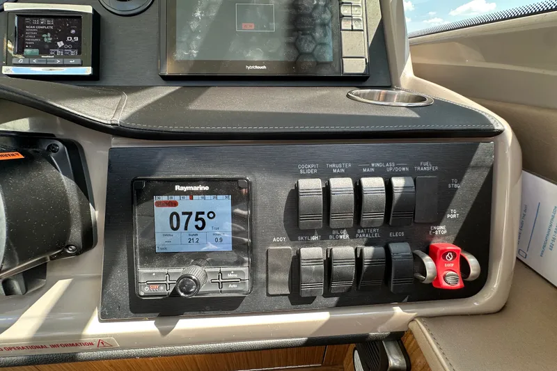 Slide: The Image of Control panel of a 2017 Sea Ray Sundancer 460 yacht with navigation and switch controls. - 23