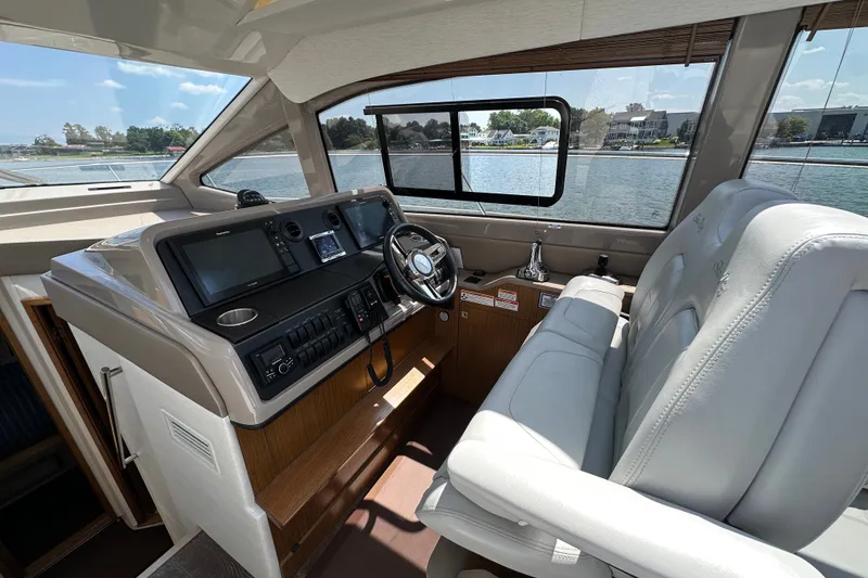 Slide: The Image of 2017 Sea Ray Sundancer 460 helm with modern controls and waterfront view. - 19