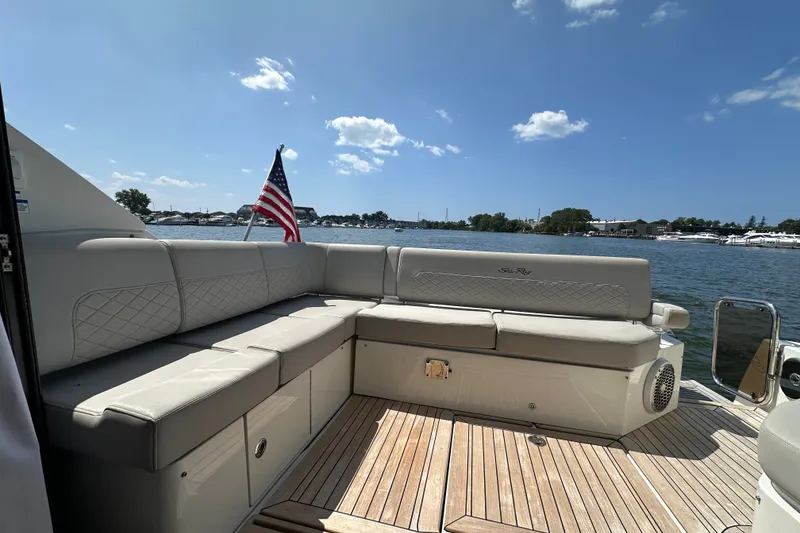 Slide: The Image of Luxurious 2017 Sea Ray Sundancer 460 yacht deck with seating and American flag. - 9
