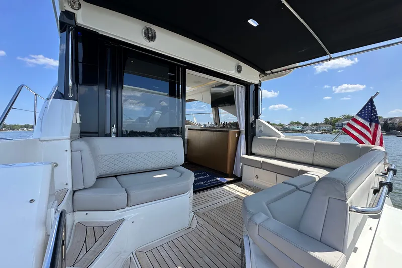 Slide: The Image of Luxurious 2017 Sea Ray Sundancer 460 yacht interior with elegant seating and American flag. - 6