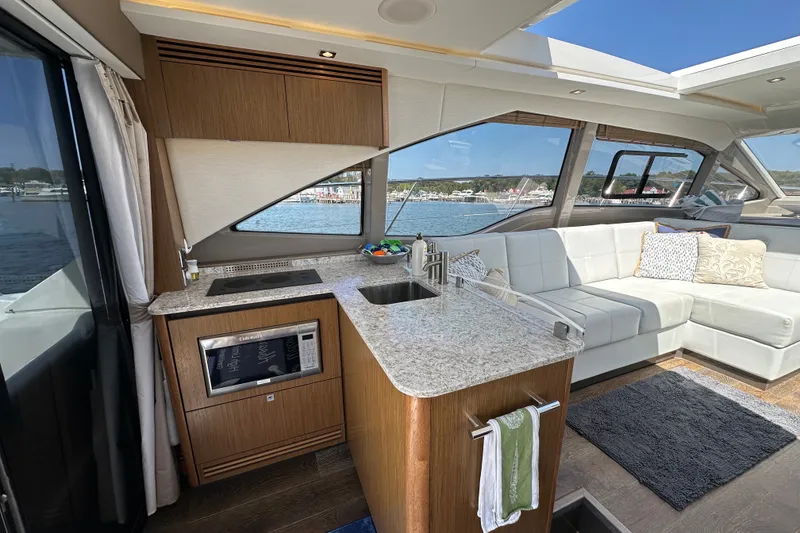 Slide: The Image of Luxurious interior of 2017 Sea Ray Sundancer 460 yacht with modern kitchen and seating area. - 11