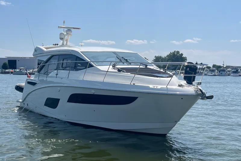 Slide: The Image of 2017 Sea Ray Sundancer 460 yacht on calm water, clear sky background. - 2
