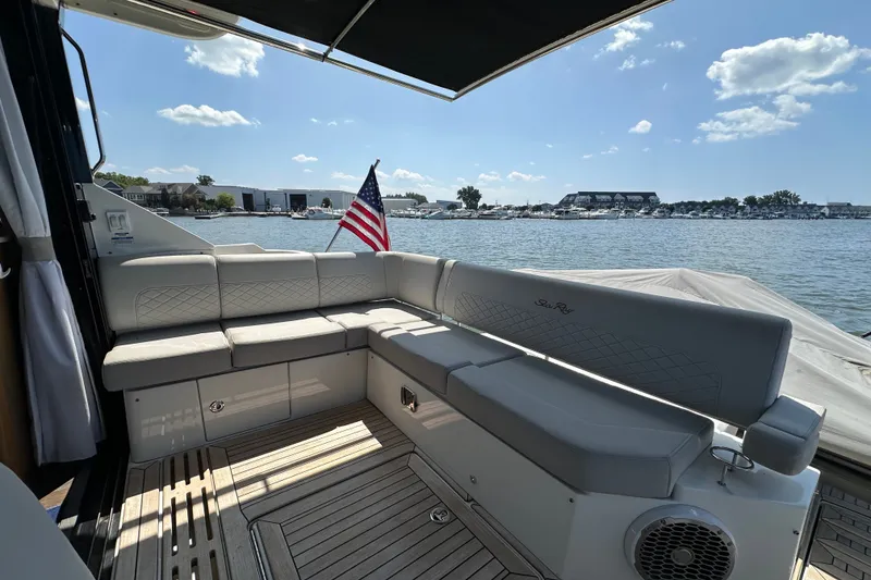 Slide: The Image of Luxurious 2017 Sea Ray Sundancer 460 yacht deck with seating, American flag, and waterfront view. - 7