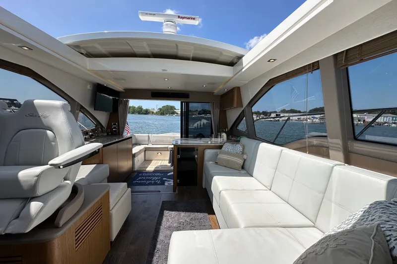 Slide: The Image of Luxurious interior of 2017 Sea Ray Sundancer 460 yacht with spacious seating and scenic water view. - 16